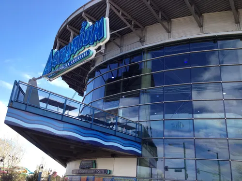 Glass facades of the Downtown Aquarium reflecting the Colorado sky