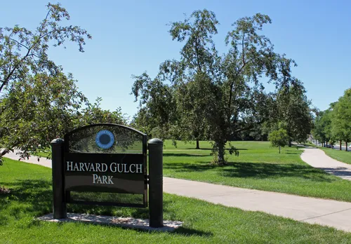 The northwest corner of Harvard Gulch Park with its entrance sign