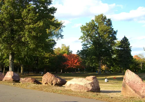 Massive rocks arranged among autumn trees