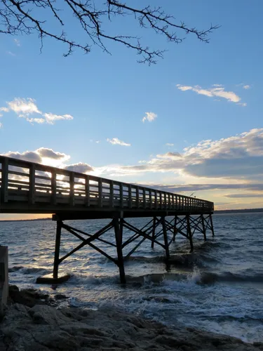 Wooden pier stretches into the evening waters