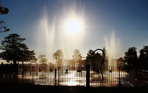 Water playground fountains create a spectacular sun-backlit display