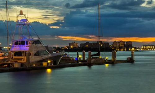 Boats docked at the marina on a cloudy evening