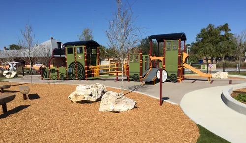 Children's playground area featuring natural wood elements and colorful equipment