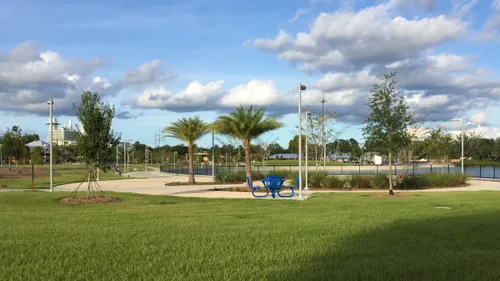Open green space with young trees and walking paths