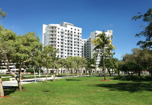 Lush green lawn with residential towers rising in the background