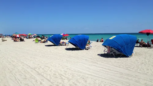 Beachgoers enjoying pristine white sands along the turquoise shoreline
