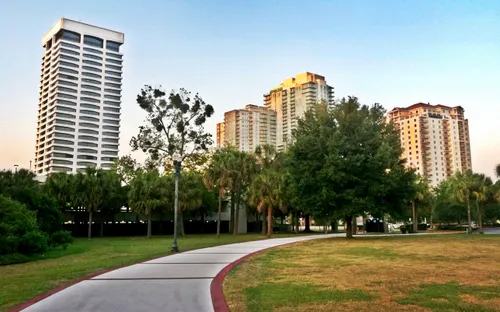 A pathway through the park with Jacksonville towers in background