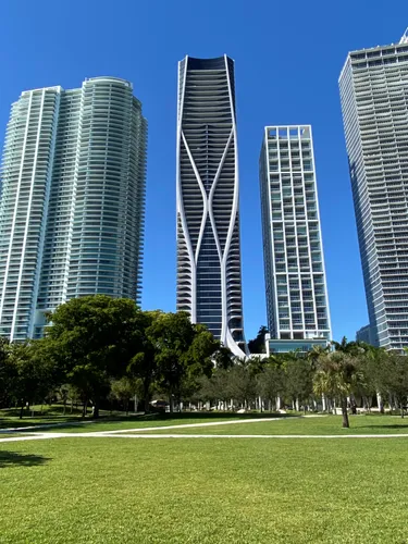 Lush green lawn offers views of Miami's tall skyscrapers