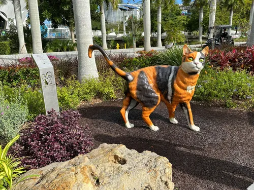 Orange cat sculpture stands in the Dogs and Cats Walkway garden