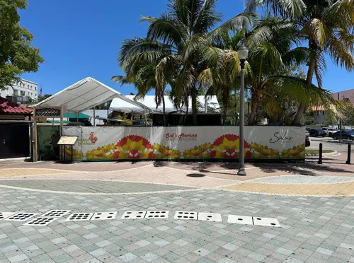 Painted dominoes on the ground next to the park