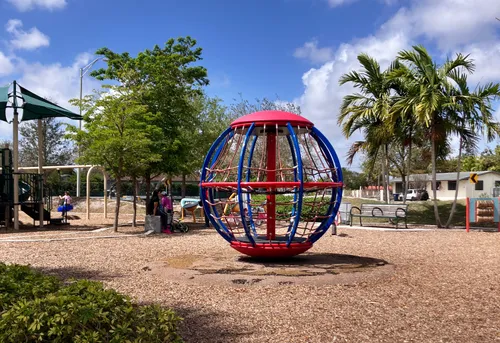 A spherical climbing structure sits at the center of the play area