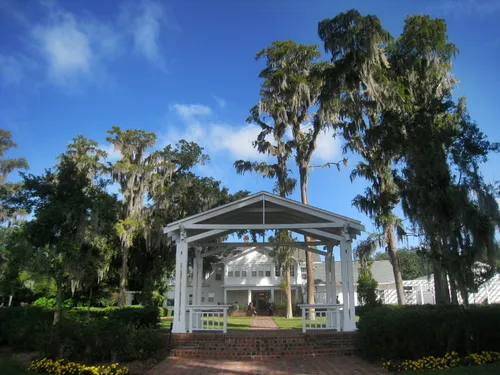 White gazebo surrounded by Spanish moss-draped trees at Cypress Grove Estate House