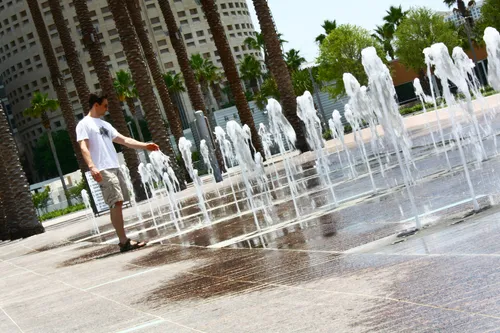 Visitor by the fountains on a sunny day