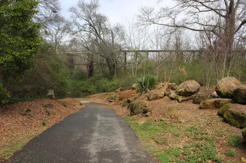 A paved path leads from the parking lot down toward Trail Creek