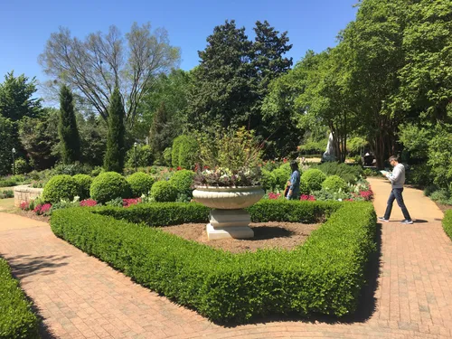 Formal garden with precisely trimmed hedges and clean pathways