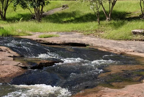 Clear flat water rushes across the rocky bed of Flatrock Creek