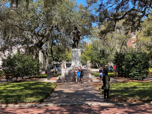 Visitors have their picture taken in front of the monument