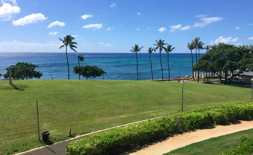 Sweeping green lawns meet the ocean at the edge of the park
