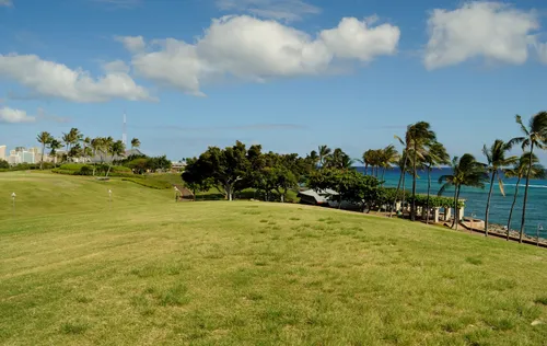 Open green lawns stretch toward the ocean