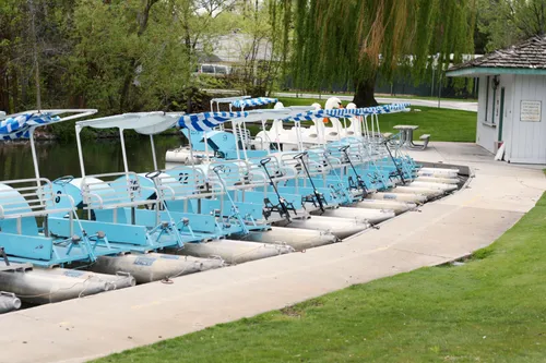 Row of blue paddle boats awaiting riders by the lake