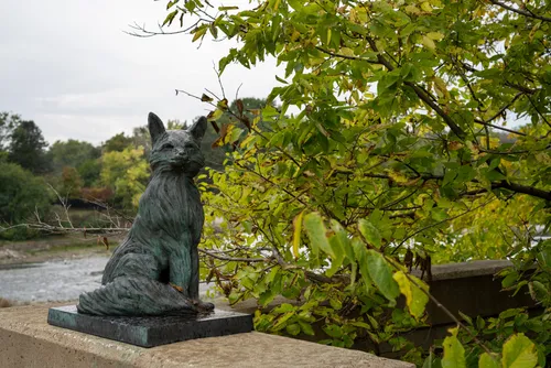 A fox statue sits on the West State Street Bridge wall above the Fox River