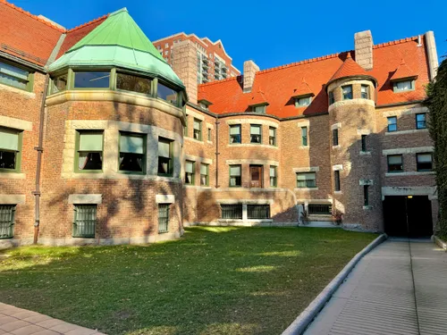 The courtyard facade of Glessner House features red brick and conical-roofed towers