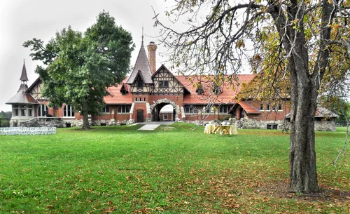 Historic Stables building showcases distinctive red brick architecture amid autumn foliage