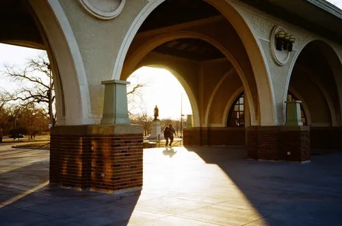 Sunlight streams through the arched entryway of the Boathouse Gallery