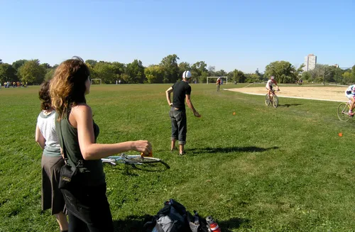 Visitors enjoying the open green space during a bike race