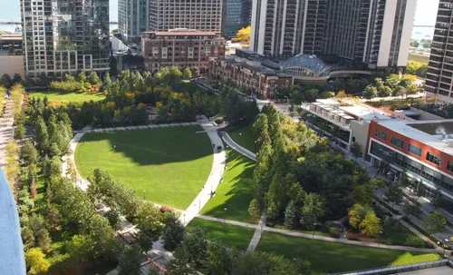 Aerial view of the park's green lawns and curved paths amid Chicago's skyline