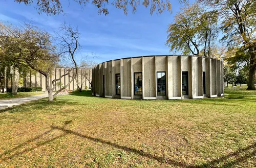 The fieldhouse sits amid open green space and trees
