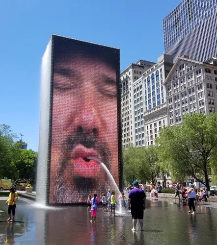 Crown Fountain displays one of its rotating facial projections and sprays water