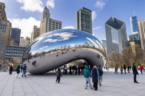 Cloud Gate sculpture reflects visitors gathering below