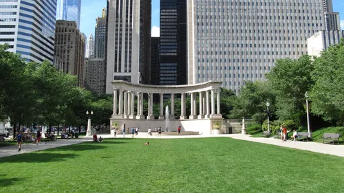 A green expanse leads to the classical columns of the Millennium Monument