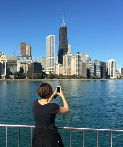 A visitor photographs the Chicago skyline from the waterfront