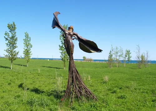 Bronze sculpture surrounded by prairie grasses in Daphne Garden
