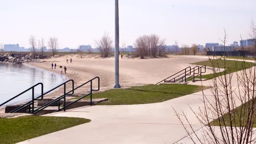 Concrete pathway and stairs leading to a beach area