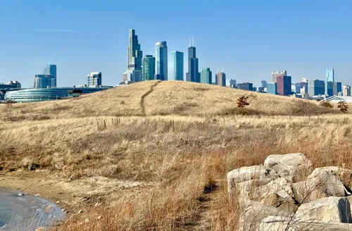 Rocky promontory with skyscrapers visible in the distance