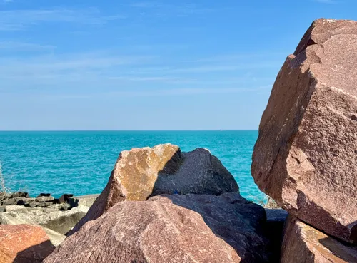 Granite stones separate the park's east shore from Lake Michigan