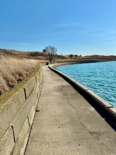 Paved walkway hugs the western shoreline of the island