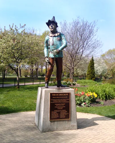 The Scarecrow statue surrounded by spring greenery