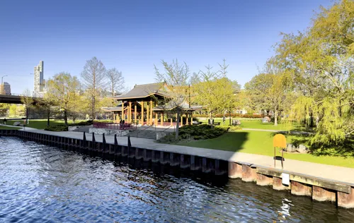 Wooden dock extending into the river with pavilion shelter