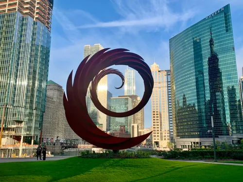Red spiral sculpture Constellation by Santiago Calatrava in front of Chicago towers