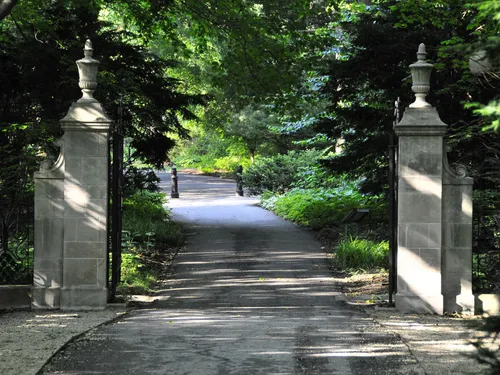 Stone pillars frame the entrance pathway into the gardens
