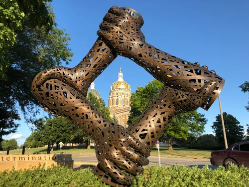 Workers' Monument sculpture frames the golden Capitol dome