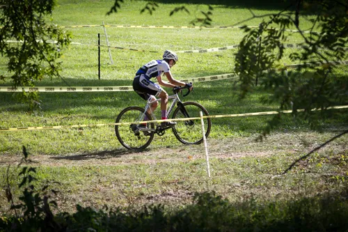 Cyclist navigating a grassy course during a cyclocross race at the park