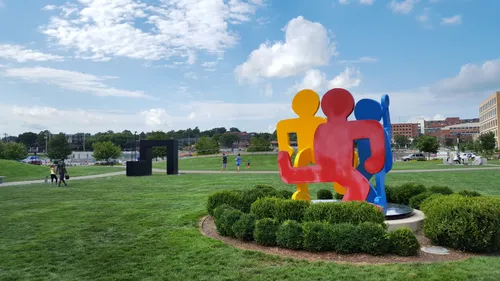 This is Keith Haring's Untitled sculpture with Tony Smith's geometric Marriage visible behind it