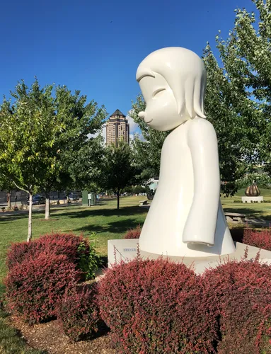Yoshitomo Nara's fiberglass sculpture White Ghost sits among red foliage