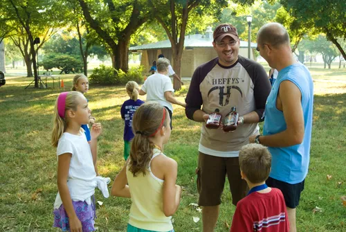 Park visitors discussing barbecue sauces