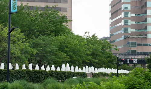Row of white fountain jets lining the edge of Triangle Park